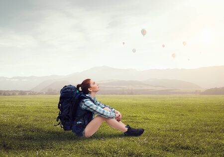 Girl hiker having rest. Mixed mediaの写真素材