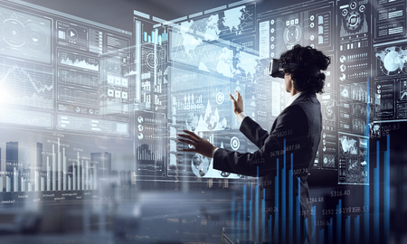 Young businessman uses a virtual reality glasses. Mixed mediaの写真素材