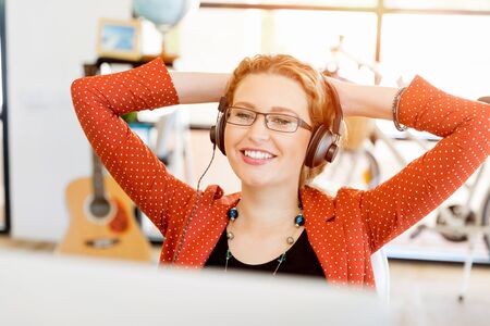 Young woman holding mobile phone in officeの写真素材
