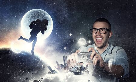 Guy with retro photocamera. Mixed mediaの写真素材