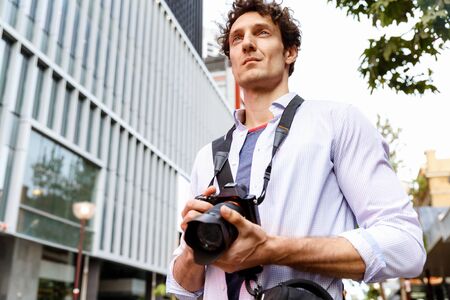 Male photographer taking pictureの写真素材