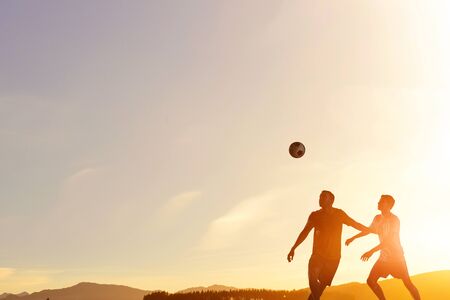 Silhouettes of two soccer playersの写真素材