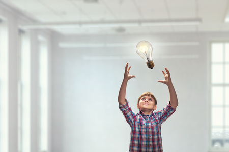 Boy catch light bulb. Mixed mediaの写真素材