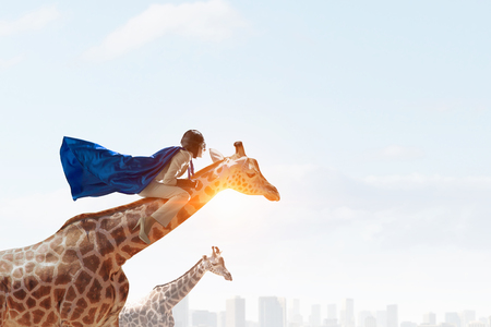 Girl saddle giraffe . Mixed mediaの写真素材