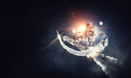 Astronaut surfing dark sky. Mixed mediaの写真素材