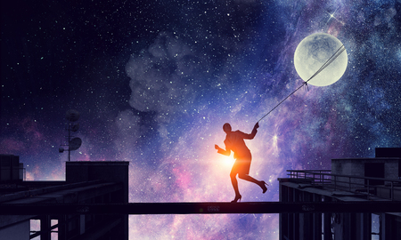 Woman catching moon . Mixed mediaの写真素材