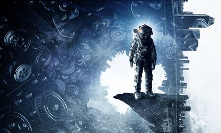 Astronaut against dark background with gears and cogwheels. Mixed mediaの写真素材