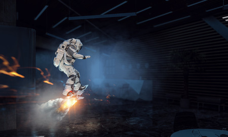 Astronaut flying in the sky on futuristic board. Mixed mediaの写真素材