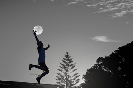 Silhouette of basketball player outdoor throwing ball . Mixed mediaの写真素材