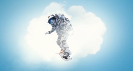 Spaceman on flying board. Mixed mediaの写真素材