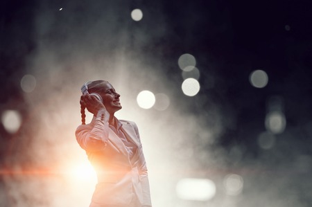 Woman wearing white headphones. Mixed mediaの写真素材