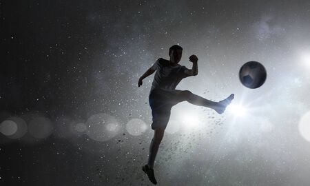 Soccer player with ball outdoorsの写真素材