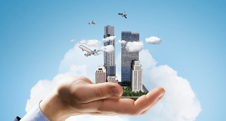 Mini exterior city model presented in palm. Mixed mediaの写真素材