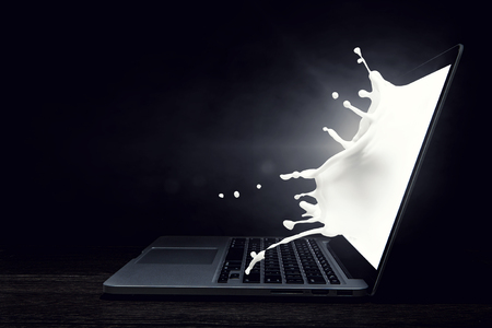 Laptop in smoke on dark background. Mixed mediaの写真素材