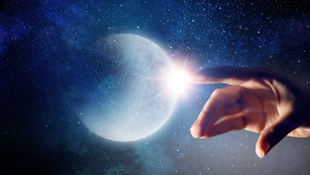 Hand touching the moonの写真素材