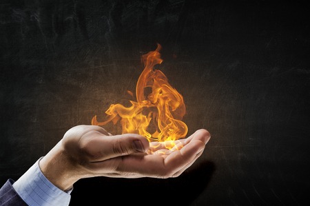 Fire burning in his handsの写真素材