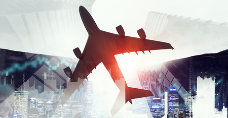 Bottom view of airplane above city. Mixed mediaの写真素材