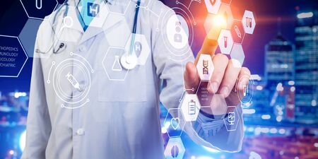 Close up of male doctor touching virtual screen. Mixed mediaの写真素材