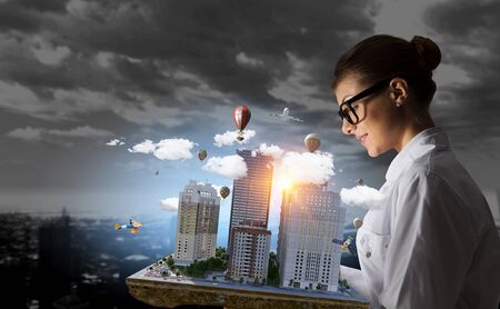 Woman presenting construction model. Mixed mediaの写真素材