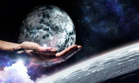 Earth planet in palm. Elements of this image are furnished by NASAの写真素材