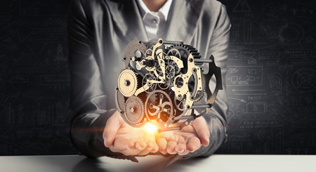 Cogwheel mechanism in hand. Mixed mediaの写真素材