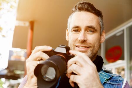 Male photographer taking pictureの写真素材
