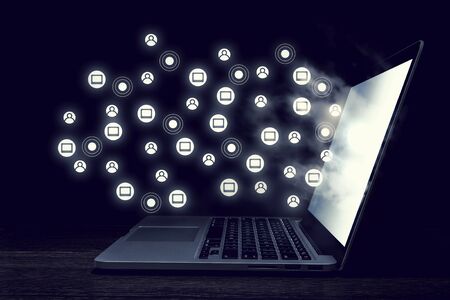 Opened laptop on dark background and connection grid. 3d renderingの写真素材