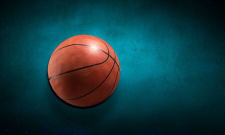 Basketball brown ball on color floor backgroundの写真素材