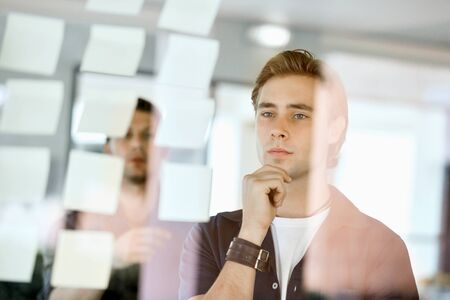 Sticky-notes on a glass wallの写真素材