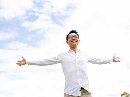 Young happy and successful businessman during his break in parkの写真素材