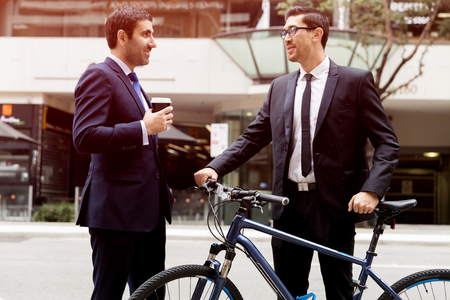 Young businessmen with a bikeの写真素材