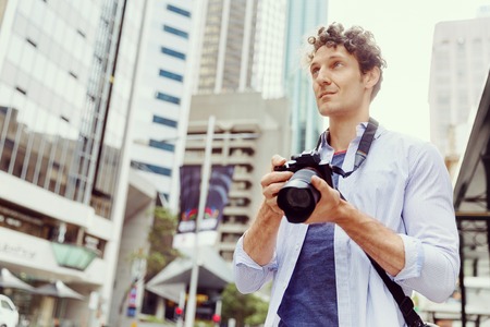 Male photographer taking pictureの写真素材