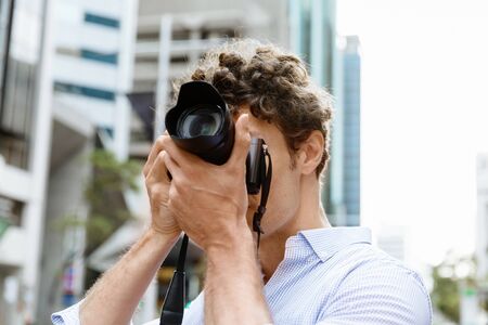 Male photographer taking pictureの写真素材