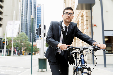 Young businessmen with a bikeの写真素材