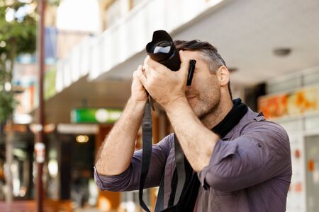 Male photographer taking pictureの写真素材
