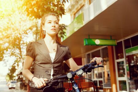 Young woman commuting on bicycleの写真素材