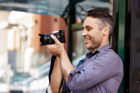 Male photographer taking pictureの写真素材