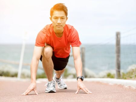 Young man getting ready for a runの写真素材