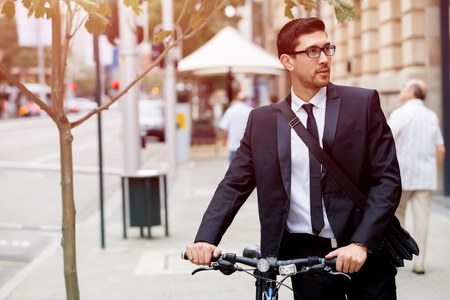 Young businessmen with a bikeの写真素材