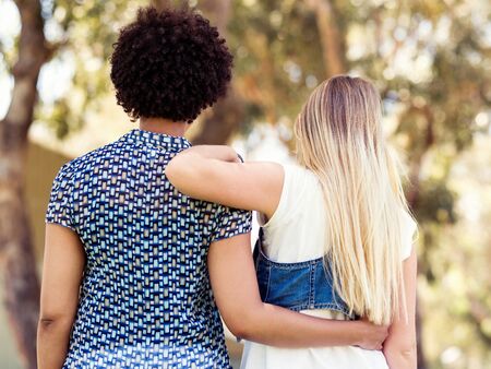 Two women friends in parkの写真素材