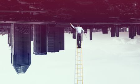Businessman on ladderの写真素材