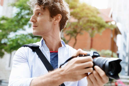 Male photographer taking pictureの写真素材