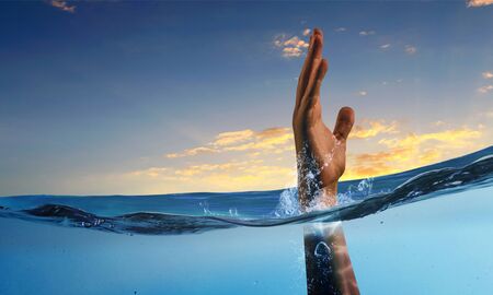 Hand of person drowning in waterの写真素材