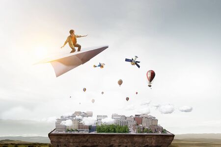 Hipster guy surfing sky . Mixed mediaの写真素材