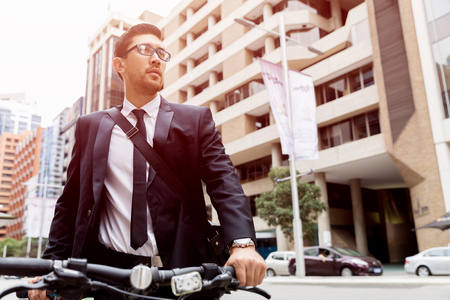 Young businessmen with a bikeの写真素材