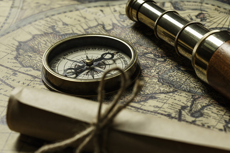 Retro compass with old map and spyglass