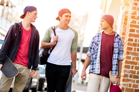 Teenage friends walking at the streetの写真素材