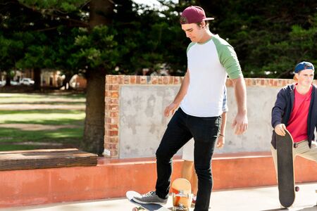 Teenage boys skateboarding outdoorsの写真素材