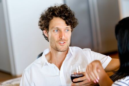 Portrait of a couple having a glass of red wineの写真素材