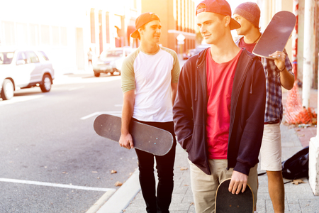 Teenage friends walking at the streetの写真素材